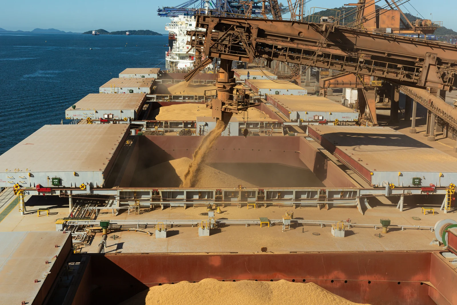 Dry bulk cargo being loaded into a ship's holds